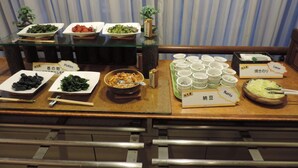 A buffet with various dishes and drinks, including pickles, a bowl of pasta, and several cups of tea. - Hotel Grand Terrace Sendai Kokubuncho (Sendai)