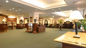 A lobby with a carpeted floor, wooden furniture, a reception desk, and a chandelier. - Hotel Grand Terrace Sendai Kokubuncho (Sendai)