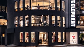 A building with a prominent "BLUE ELEPHANT" sign, featuring multiple floors with large windows and a modern architectural design. - Kent Hotel Gwangalli by Kensington (Busan)