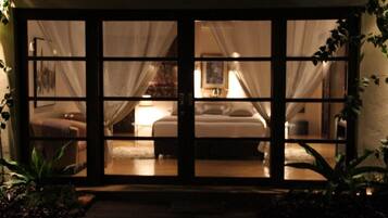 A room with a bed, a bedside table, and a lamp.