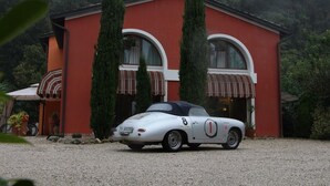A white convertible car with the number 1 parked in front of a red building with arched windows and a striped awning. - Country Home B&B Il Melo (Vicenza)