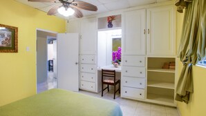 A bedroom with a bed, a desk, and a wardrobe. - BK Villas (Maxwell)