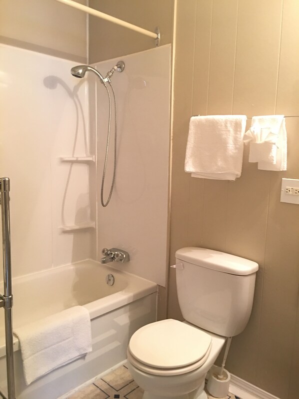 Economy kamer, 1 queensize bed, kitchenette | Badkamer | Een douche, gratis toiletartikelen, handdoeken