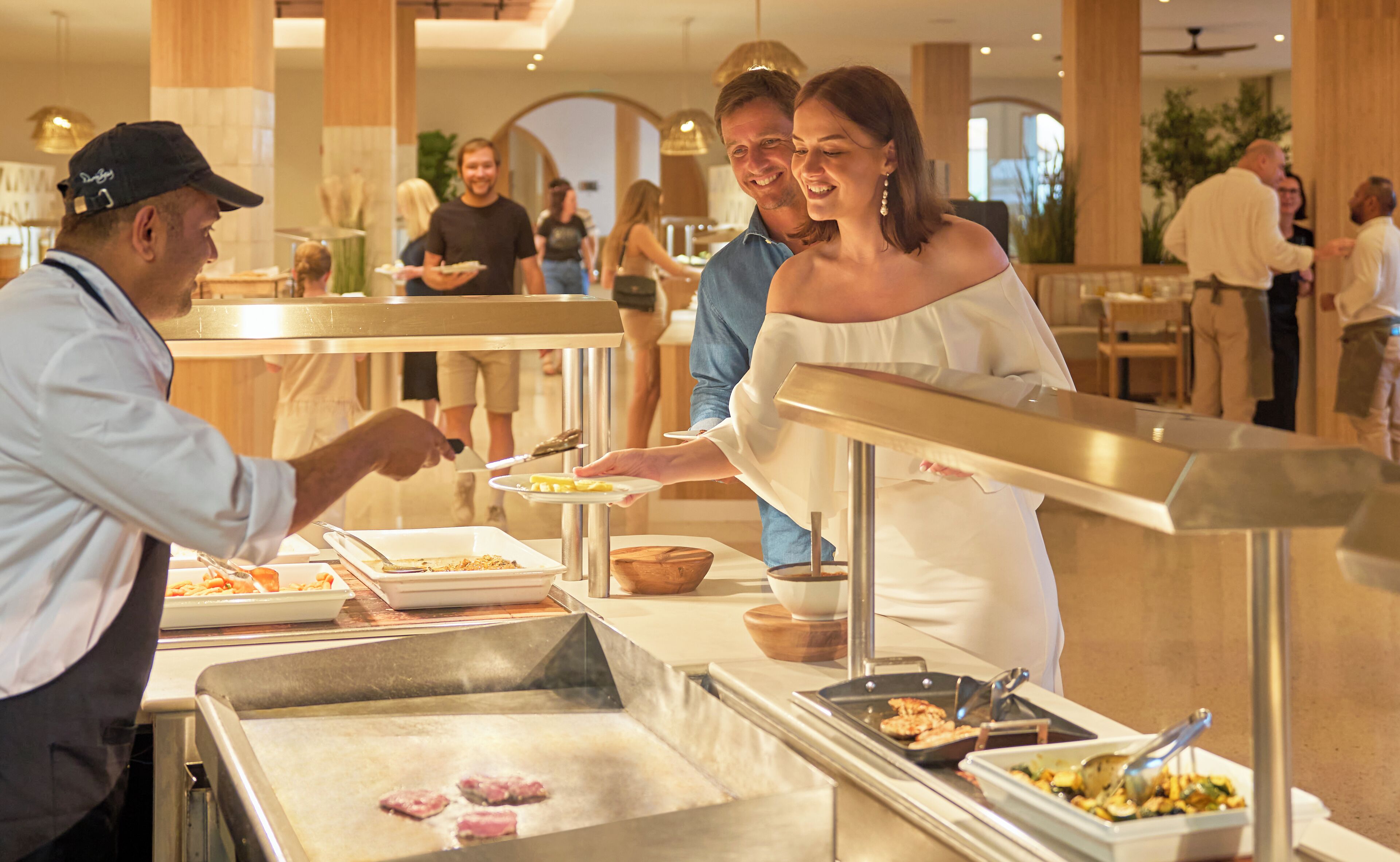 A buffet setup with various food items and a serving counter.