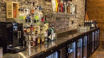 A bar area with a variety of liquor bottles and a beer tap system.