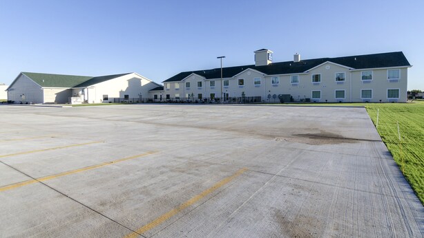 A large building with multiple windows and a flat roof, likely a hotel or apartment complex.