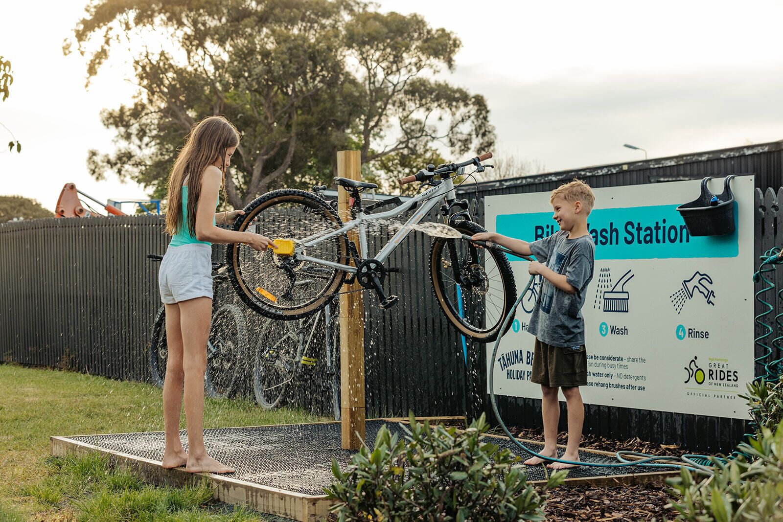 A wash station with a bicycle being washed.