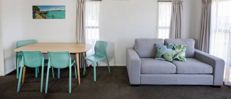 Classic Two Bedroom Motel Sleeps 5 | Living area | 20-inch flat-screen TV with cable channels, TV, books