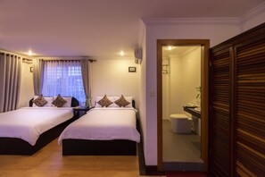 A hotel room with two beds, a bathroom, and a view of the city. - Angkor Ry Boutique (Siem Reap)