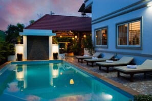 A swimming pool with lounge chairs and a covered patio area. - Angkor Ry Boutique (Siem Reap)