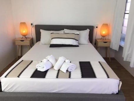 Escritorio, cortinas blackout y tabla de planchar con plancha