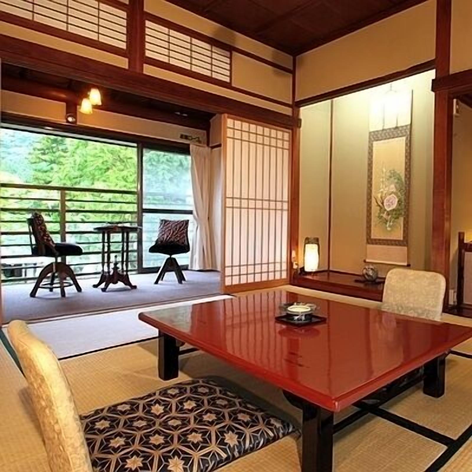 A traditional Japanese-style room with tatami flooring, a low wooden table, and a shoji screen.