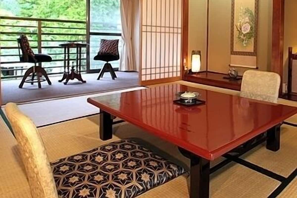A traditional Japanese-style room with tatami flooring, a low wooden table, and a shoji screen.
