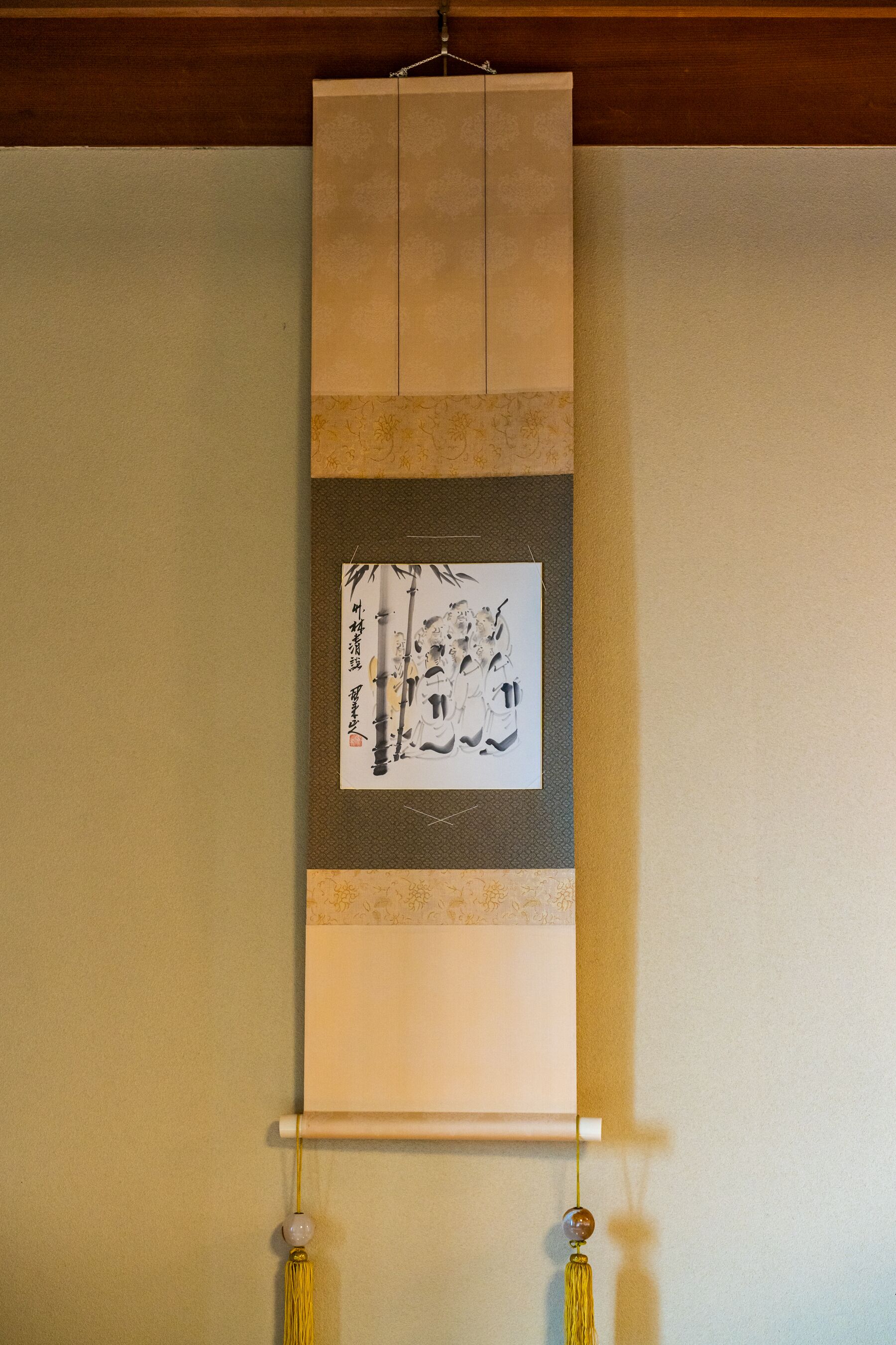 A traditional Japanese shoji screen with calligraphy and a hanging scroll.