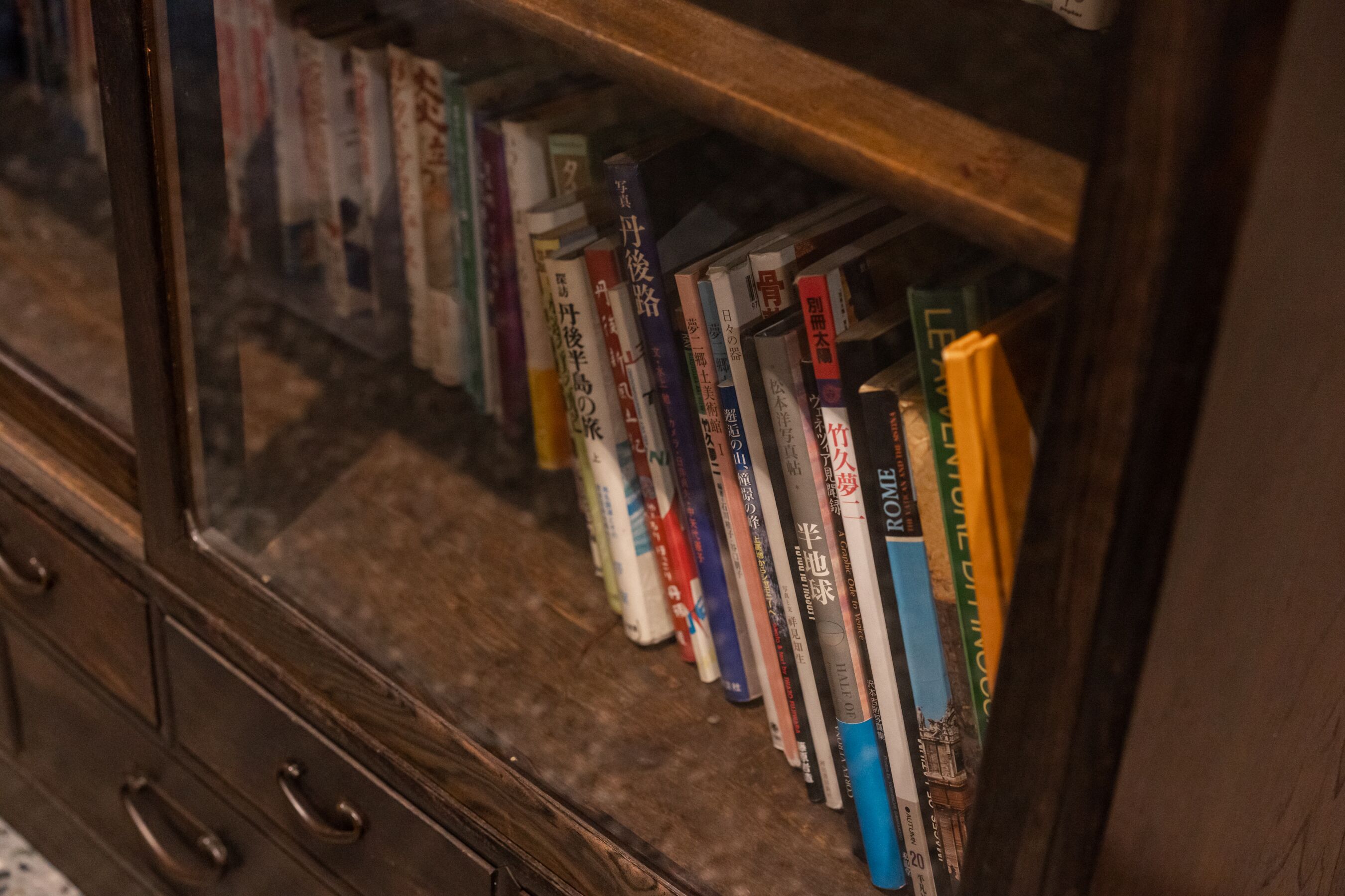 A wooden bookshelf with books.