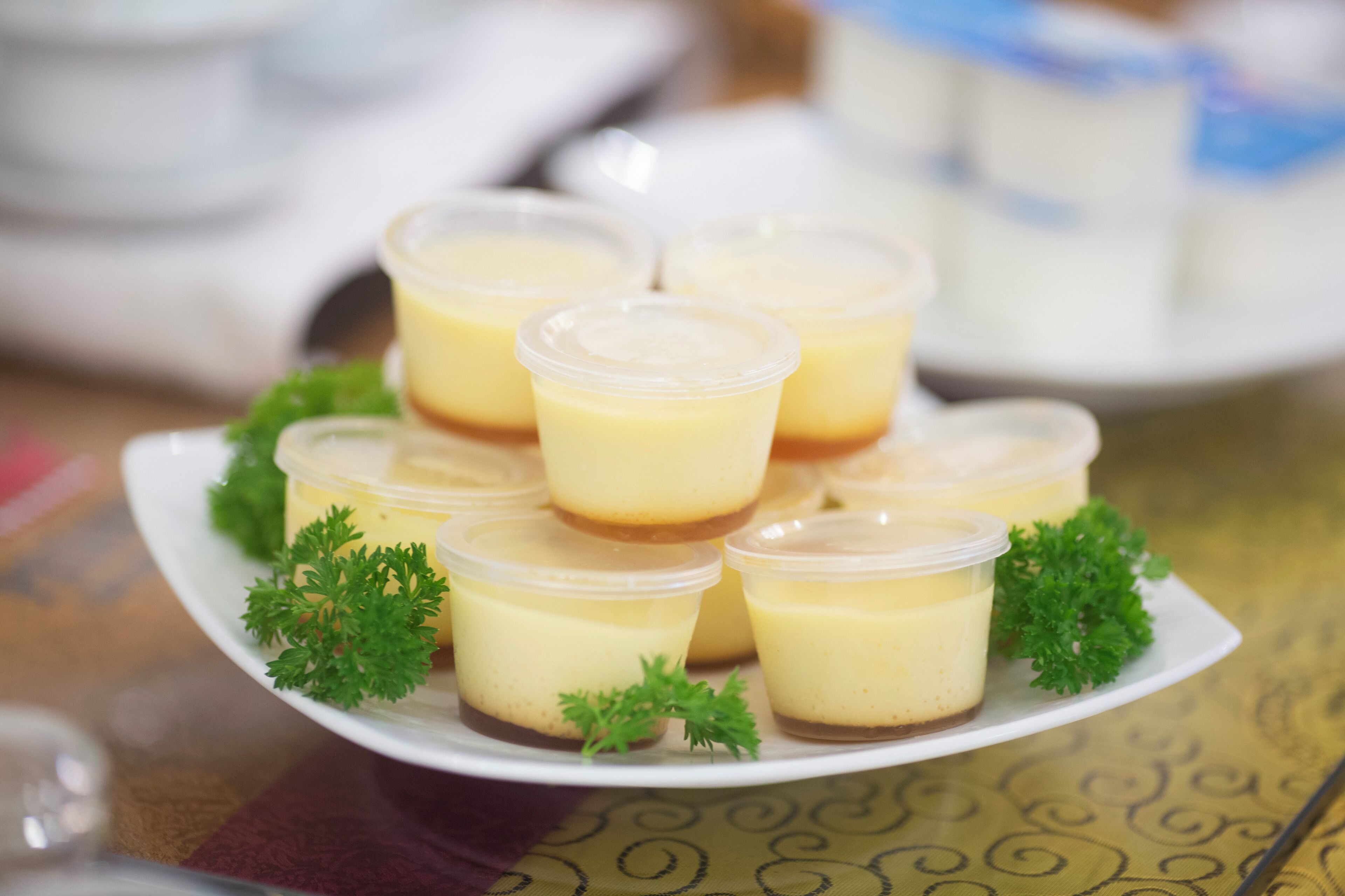 A plate of custard cups with a garnish of parsley.