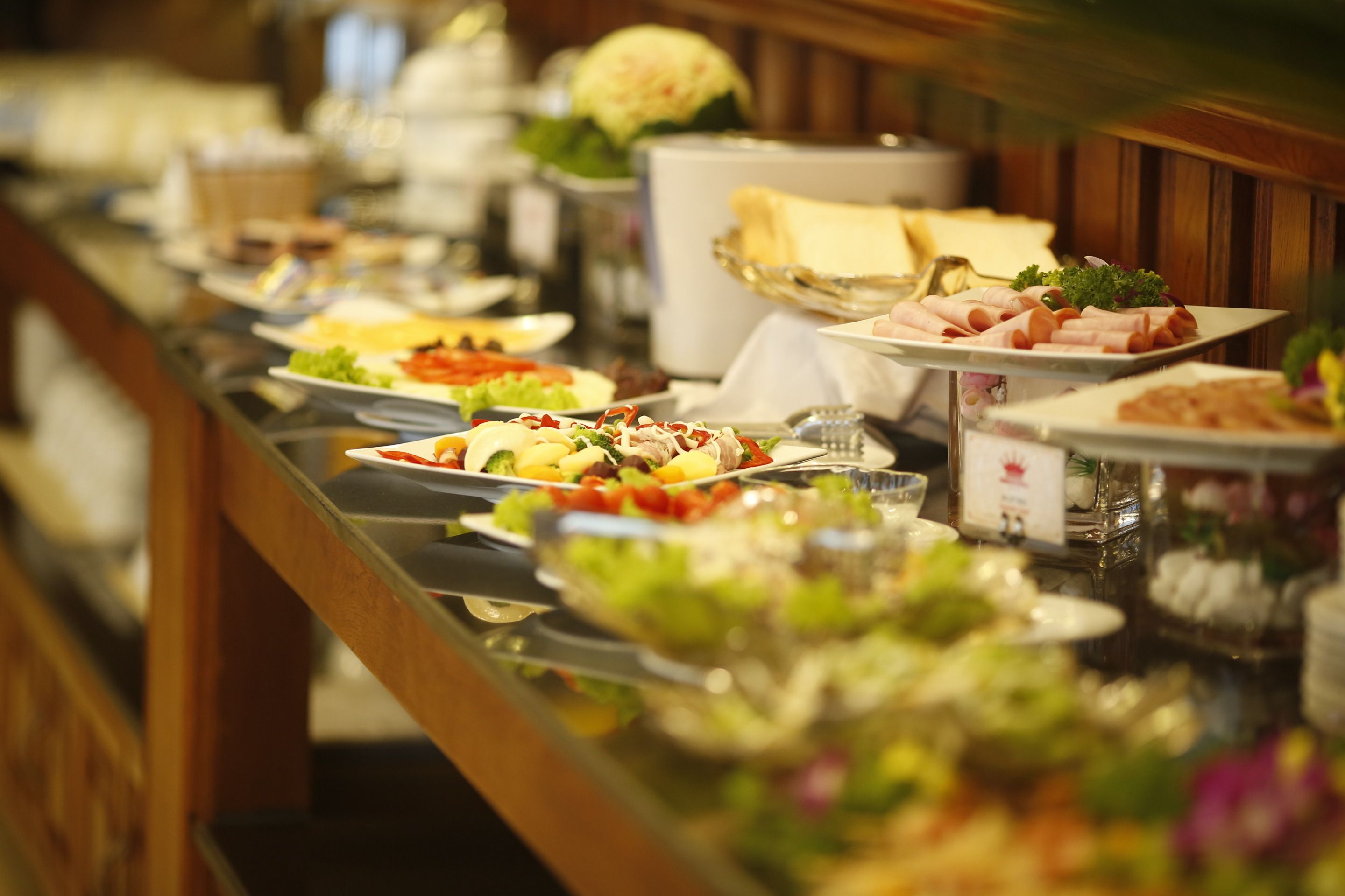 A buffet with various dishes and a salad bar.