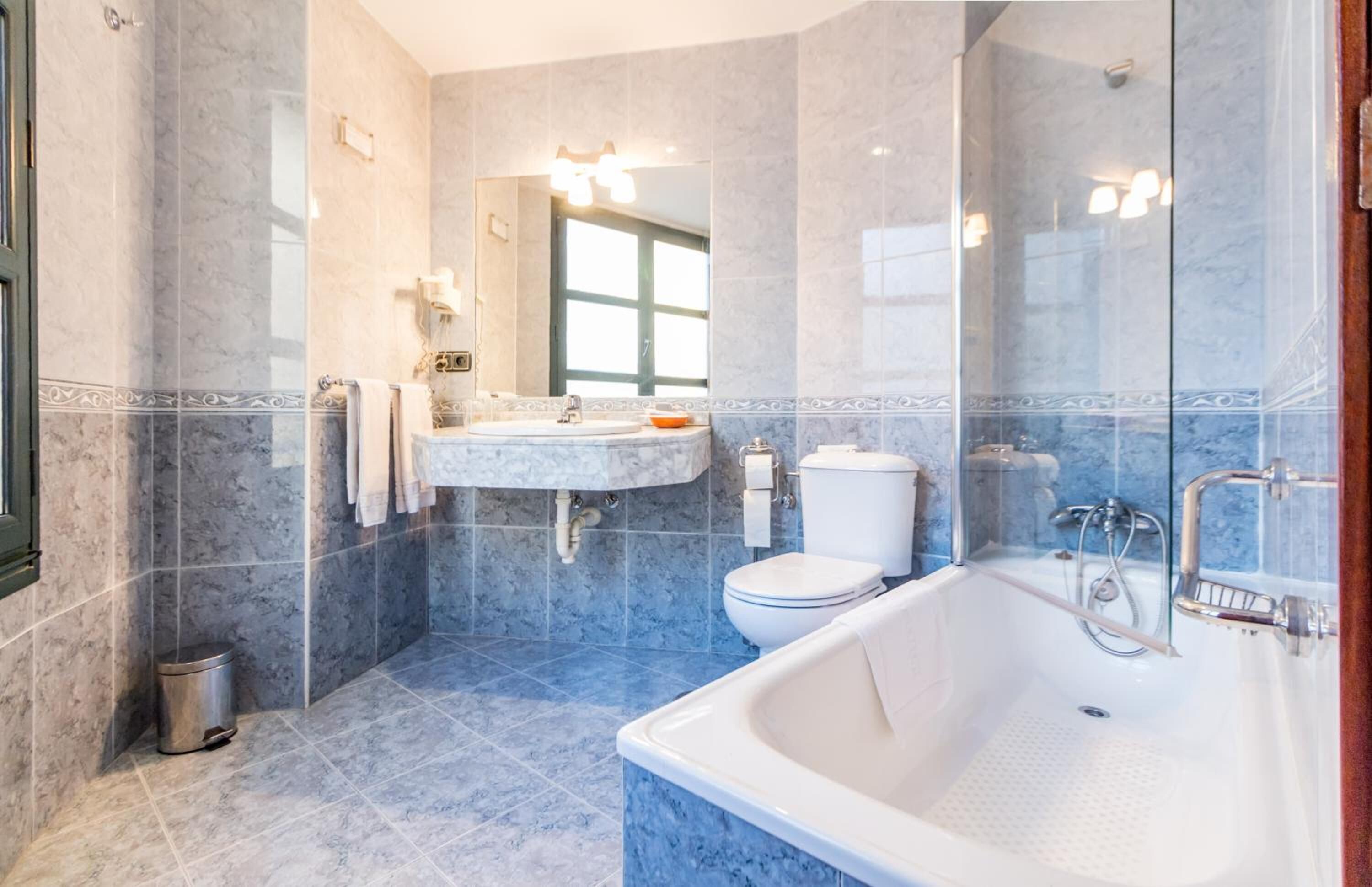 bathtub, free toiletries, hair dryer, towels