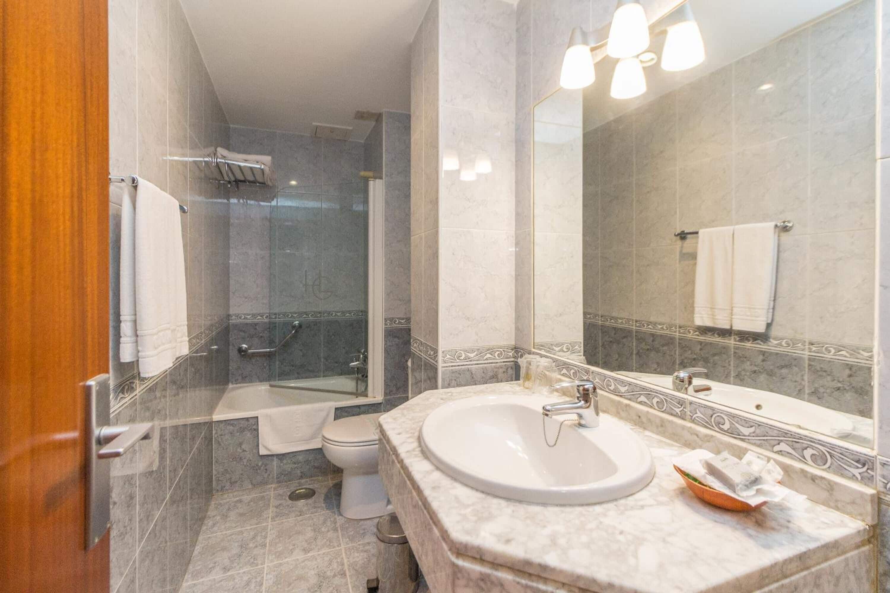 bathtub, free toiletries, hair dryer, towels