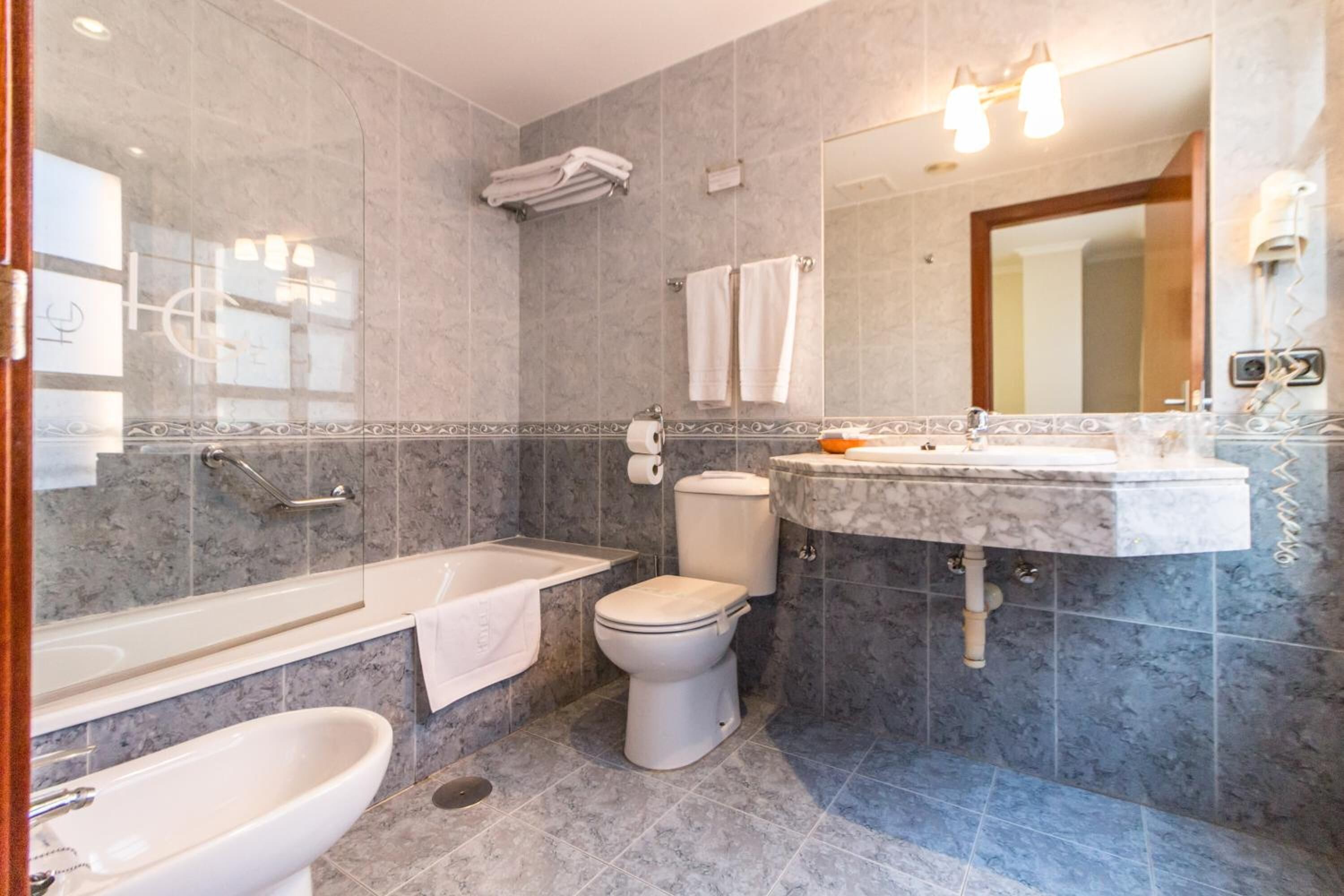 bathtub, free toiletries, hair dryer, towels