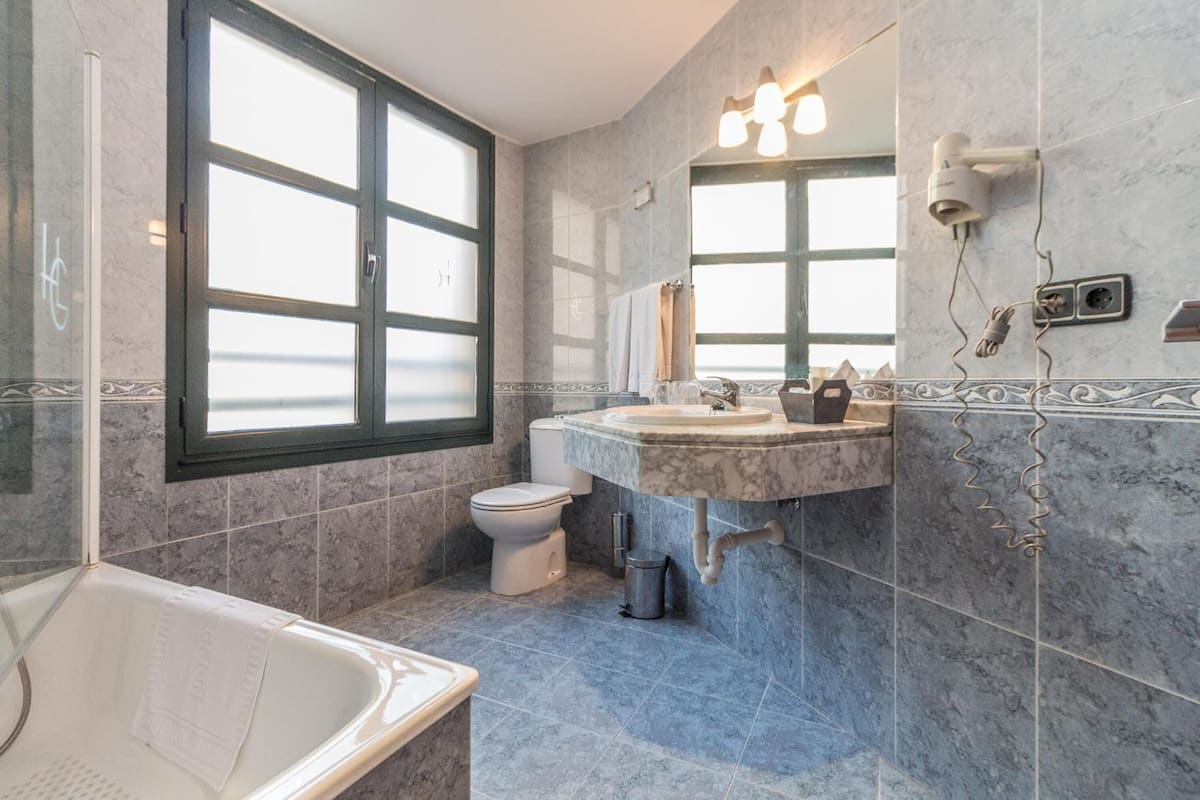 bathtub, free toiletries, hair dryer, towels