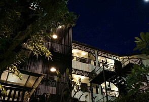 A multi-story building with balconies and a staircase.