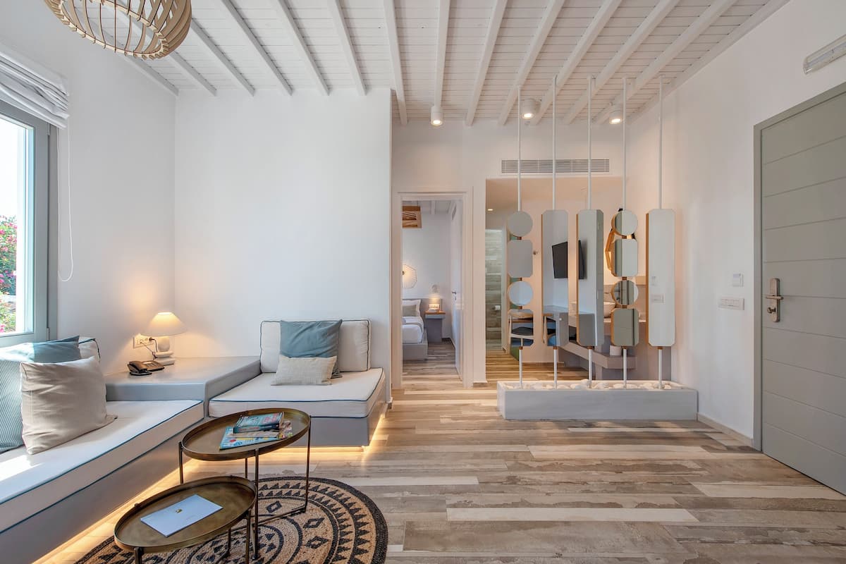 A modern living room with a sofa, a coffee table, and a patterned rug.