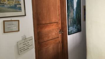 A hallway with a wooden door labeled "FREE WIFI" and a sign indicating "EXIT".