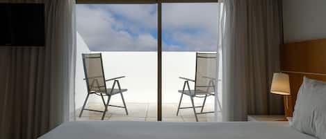 Junior Suite, Patio | Minibar, desk, laptop workspace, blackout drapes