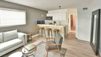 Chic Designer One Bedroom and One Queen Bed Full Kitchen | Living area | 42-inch flat-screen TV with cable channels, TV, iPod dock