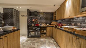 A modern kitchen with a black and white tiled backsplash, wooden cabinets, and a stainless steel sink.