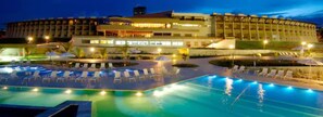 A hotel with a swimming pool, lounge chairs, and a well-lit outdoor area. - Garden Hotel Campina Grande (Campina Grande)