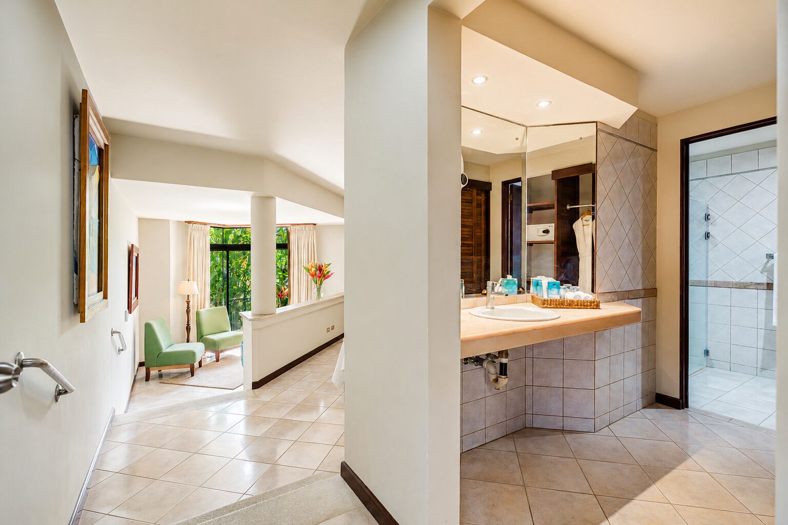A modern bathroom with a large mirror, a sink, and a shower area.