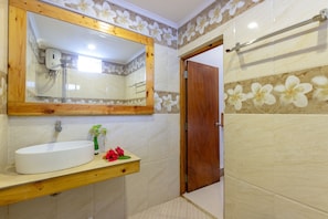 A bathroom with a wooden vanity, a large mirror, and a shower area. - Dream Inn Sun Beach Hotel (Thulusdhoo Island)