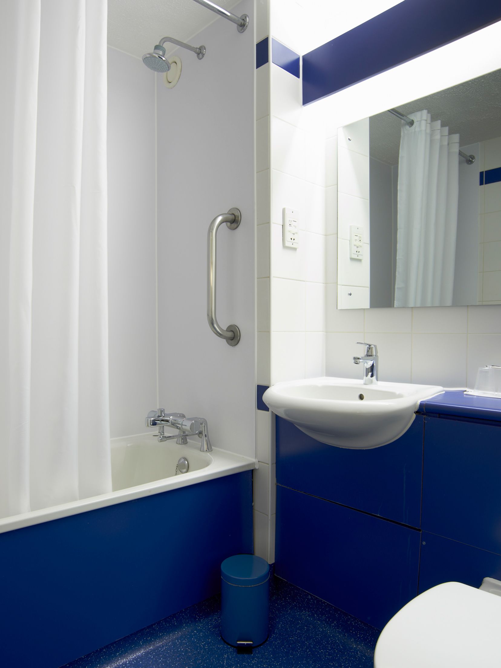 A bathroom with a bathtub, a sink, a toilet, and a shower.