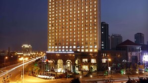 A high-rise hotel with a prominent sign at the top. - Wyndham Grand Plaza Royale Mingfa Zhangzhou (Zhangzhou)