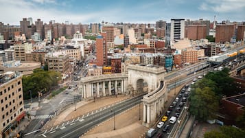 A cityscape with a prominent arch structure, busy streets, and a variety of buildings.