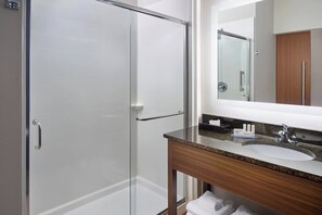 A modern bathroom with a glass shower enclosure, a wooden vanity with a sink, and a mirror above the vanity. - Fairfield Inn & Suites by Marriott Asheville Airport/Fletcher (Fletcher)