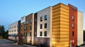 A multi-story hotel with a modern design, featuring a mix of brick and panel exteriors. - Fairfield Inn & Suites by Marriott Asheville Airport/Fletcher (Fletcher)