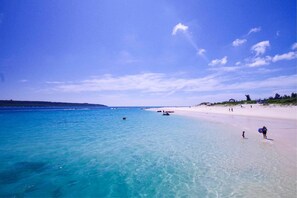 Beach nearby, white sand, beach umbrellas, beach towels
