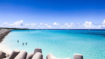 Beach nearby, white sand, beach umbrellas, beach towels