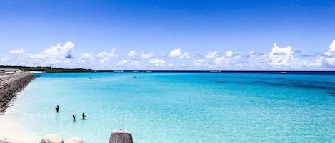 Beach nearby, white sand, beach umbrellas, beach towels