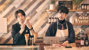 A barista preparing a drink with a laptop on the counter. - HOTEL SHE, KYOTO (Kyoto)