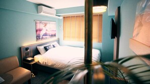A hotel room with a bed, a nightstand, a chair, a wall-mounted TV, and a window with blinds. - HOTEL SHE, KYOTO (Kyoto)