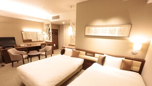 A hotel room with two beds, a desk, a chair, a television, and a wall-mounted artwork. - Hotel Monarque Tottori (Tottori)