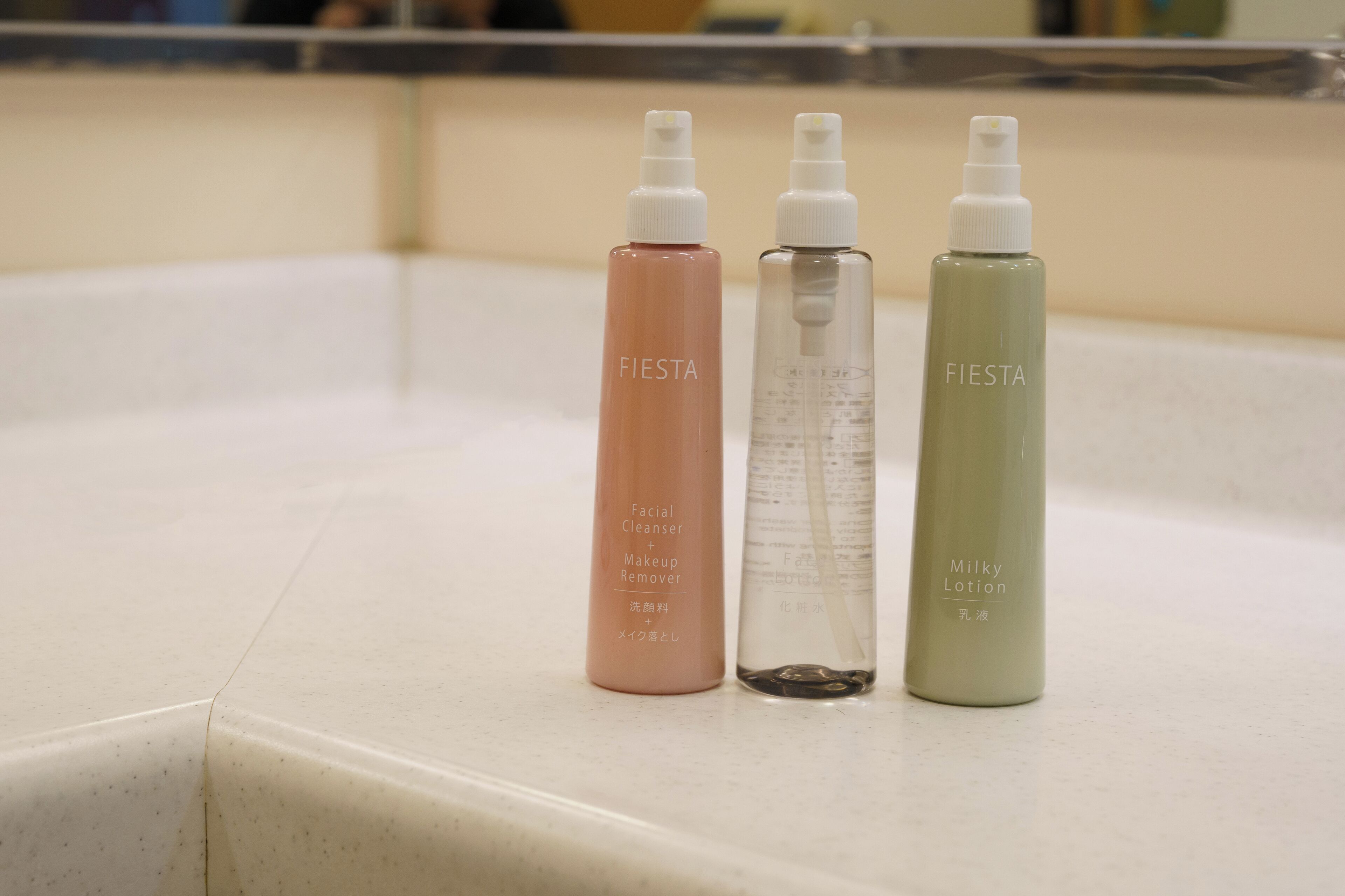 Three bottles of skincare products on a countertop.