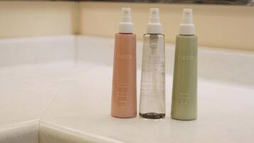 Three bottles of skincare products on a countertop.