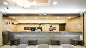 A hotel reception area with a marble counter, a clock, and a sign labeled "FRONT". - Premier Hotel Cabin Sapporo (Sapporo)