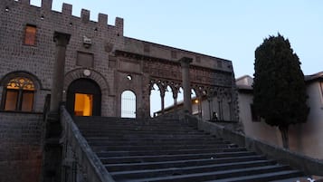 A historic stone building with a grand staircase leading to an entrance.