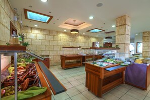 Enjoy a diverse selection of dishes at our buffet, featuring multiple serving stations and a clean, organized atmosphere.